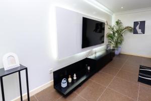 a living room with a flat screen tv on a wall at Mne villa 3 chambres in Douala