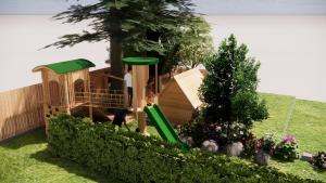 a childrens playground with a slide in a yard at Hotel Landhaus Zillertal in Fügen