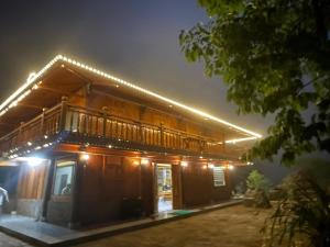 a house with a deck at night with lights at Sapa Rock Hill Homestay in Tả Van +41 photos