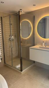 a bathroom with a shower and a sink at Hotel Restaurant Les Venetes in Arradon