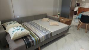 a bed with two pillows on it in a room at Family House Kat in Ioannina