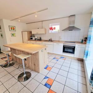 a kitchen with a wooden table and chairs in it at Fördequartier Stadtloft Flensburg in Flensburg