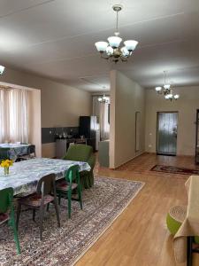 a large living room with a table and chairs at Wings Ethno in Cholpon-Ata