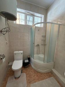 a bathroom with a shower and a toilet and a tub at Wings Ethno in Cholpon-Ata +41 photos