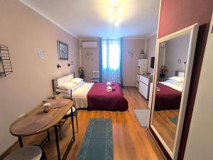 a small room with two beds and a table at Guest House Barocco in Rovinj +27 photos
