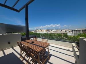 a table and chairs on a balcony with a view at O!live Fully Equipped Apartments with Unique Design in Athens