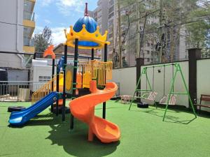 a playground with a slide in a park at Quick Connect Studio Kileleshwa in Nairobi