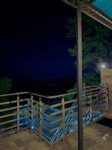 a fence at night with the ocean in the background at Go Glam Hotels Murree in Murree