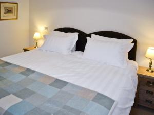 a bedroom with a large bed with white sheets and pillows at The Hayloft - Nab in Aynho