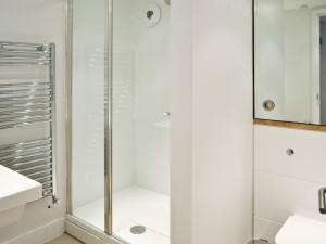 a shower with a glass door in a bathroom at The Hayloft - Nab in Aynho +4 photos