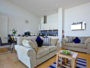 a living room with two couches and a kitchen at Bliss - Horizon View in Westward Ho +8 photos