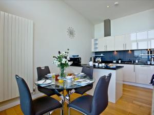 a kitchen with a table and chairs in a kitchen at Bliss - Horizon View in Westward Ho