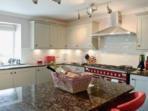 a kitchen with a counter with a basket on it at Drummuie House in Golspie