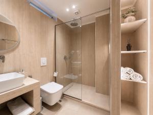 a bathroom with a shower and a toilet and a sink at Spilea Apartments in Himare +74 photos