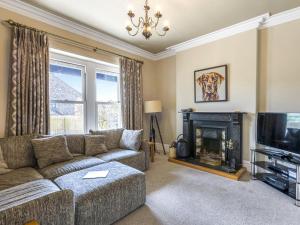 a living room with a couch and a fireplace at Mount Pleasant in Threlkeld +36 photos