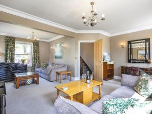 a living room with couches and a table at Mount Pleasant in Threlkeld