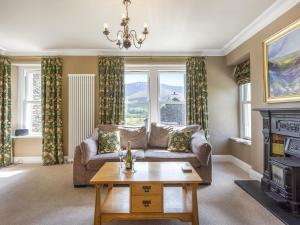 a living room with a couch and a fireplace at Mount Pleasant in Threlkeld