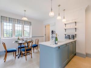 a kitchen and dining room with a table and chairs at Eagles Nest At Greyfriars - Uk33356 in Winchelsea