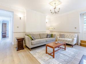 a living room with a couch and a table at Eagles Nest At Greyfriars - Uk33356 in Winchelsea