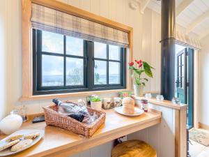 a kitchen with a table with a basket on it at Hut Uk42176 in Usk