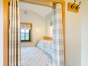 a bedroom with a bed and a window at Hut Uk42176 in Usk +13 photos