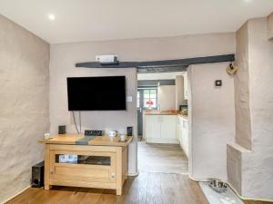 a living room with a flat screen tv on a wall at Stable Cottage in Pembroke
