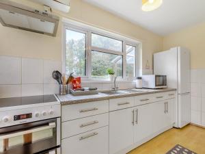 a kitchen with white appliances and a window at Pine Cottage - Uk46874 in Hartland
