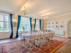a room with a long table with chairs in it at Hodroyd Hall in Holmfirth