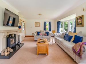 a living room with a couch and a fireplace at Cranny Hill in Walpole