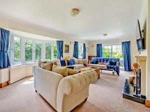 a living room with blue curtains and a couch at Cranny Hill in Walpole
