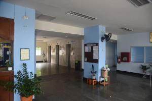 a lobby with blue pillars and potted plants at Rayong Condochain 325 in Ban Pak Khlong Phe +39 photos