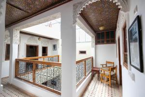 a room with a balcony with a table and chairs at Riad Medina Unique in Fez