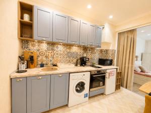 a kitchen with a sink and a washing machine at NDK - Dream House in Sofia