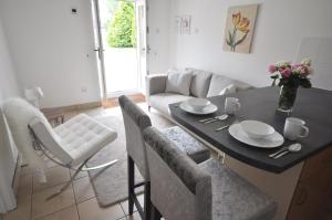 a kitchen and living room with a table and chairs at Stable Cottage 2 in Sedghill
