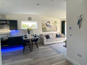 a living room with a couch and a table at Blue Heron Lodge in Brough