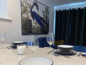 a table with wine glasses and plates on it at Blue Heron Lodge in Brough