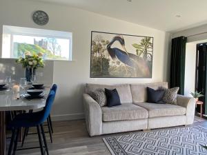 a living room with a couch and a table at Blue Heron Lodge in Brough