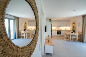 a kitchen and a living room with a mirror at Villa Yvonni in Poros