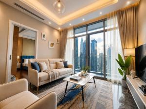 a living room with a couch and a large window at Royce Residence KLCC by Dormeo Destinations in Kuala Lumpur