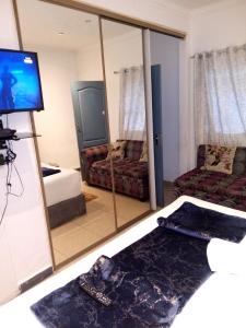 a living room with a couch and a large mirror at Lancaster Guest House in Boksburg