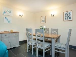 a dining room with a table and chairs at Uk45541-Old Stable Cottage in Sticklepath