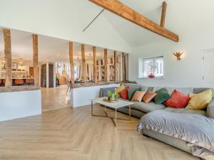 a living room with a couch and a table at Granary Barn in Ashwellthorpe