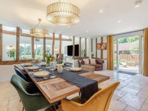 a dining room with a table and chairs at Granary Barn in Ashwellthorpe