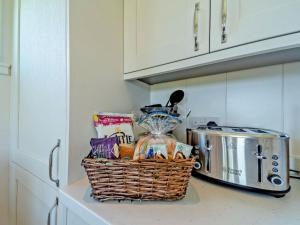 a basket of food on a counter in a kitchen at Glencoe Luxury Lodge in Erskine +12 photos
