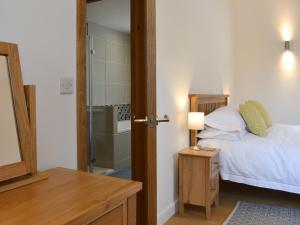 a bedroom with a bed and a bathroom with a shower at The Horse Gin - Uk11024 in East Worlington