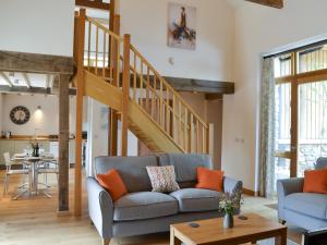a living room with a couch and a staircase at The Horse Gin - Uk11024 in East Worlington