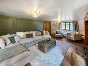 a living room with a couch and a table at Pant Ifan Goch in St Asaph