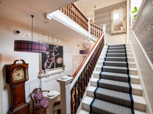 a staircase in a home with a clock at Croft House - Uk7555 in Inverness