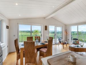a dining room with a table and chairs at Whitehill Lodge - Uk47194 in Kirkcambeck +13 photos