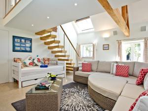 a living room with a couch and a table at Antells Farm Barn in Sturminster Newton